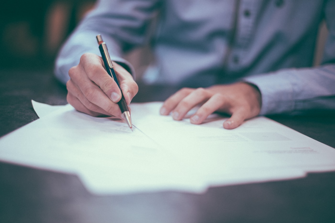 Hands reviewing printed business documents at a desk