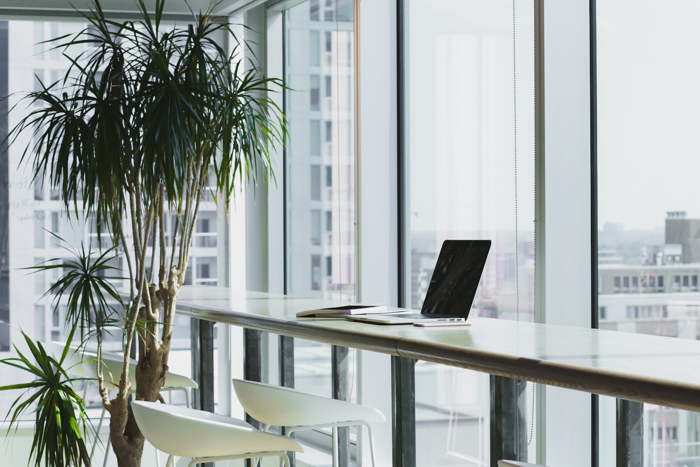 Bright, organised workspace with laptops and notebooks